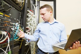 Networking administrating service. network engineer administrator checking and installing software at server hardware equipment of data center